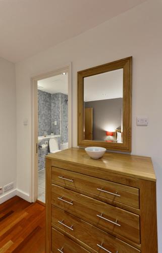 伦敦Farringdon Laceby apartments的浴室设有木制梳妆台和镜子