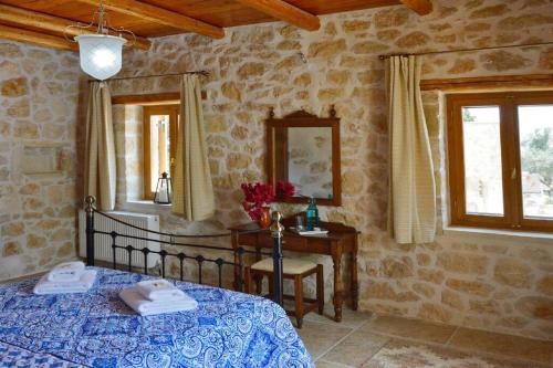 阿尔梅尼Villa Amalthiea的卧室配有床、桌子和窗户。