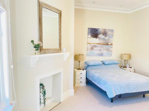 沃加沃加Classic Meets Modern in Central Wagga的白色卧室配有床和镜子