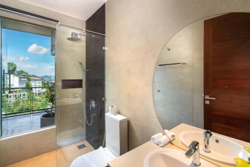 康提Grand Serendib Hotel的带淋浴、盥洗盆和镜子的浴室
