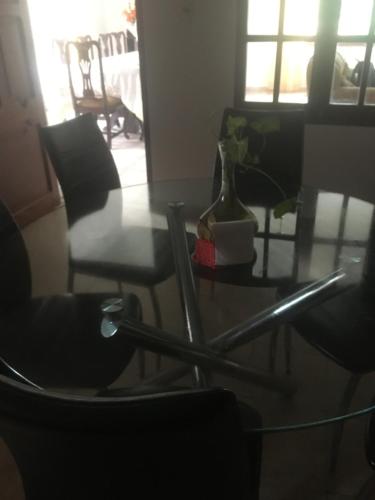塔里哈Como en tu casa的桌子和椅子,上面有花瓶