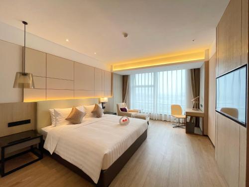 上海上海虹桥睿景酒店的酒店客房设有一张大床和一张书桌。