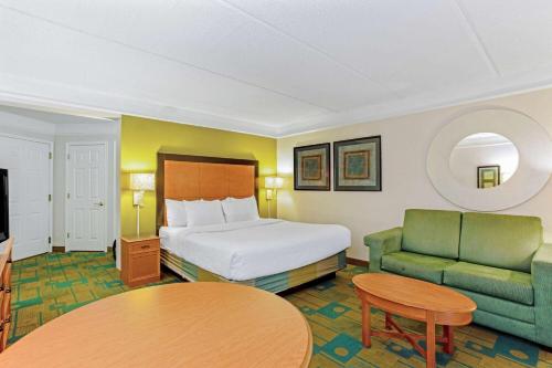 奥兰多奥兰多自行驾驶中心拉昆塔套房酒店的酒店客房配有床、沙发和桌子。