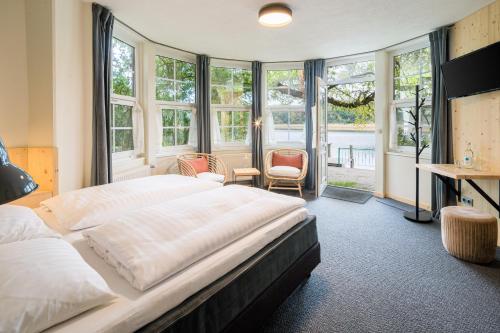 费尔德伯格浪漫希盖斯特霍夫及阿尔特斯措尔豪斯酒店的卧室配有一张床、一张书桌和窗户。