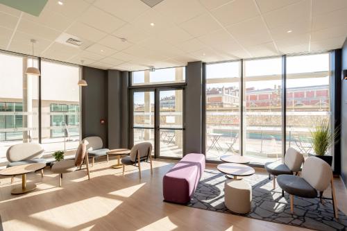 土伦B&B HOTEL Toulon Centre Gare的一间设有桌椅和窗户的等候室