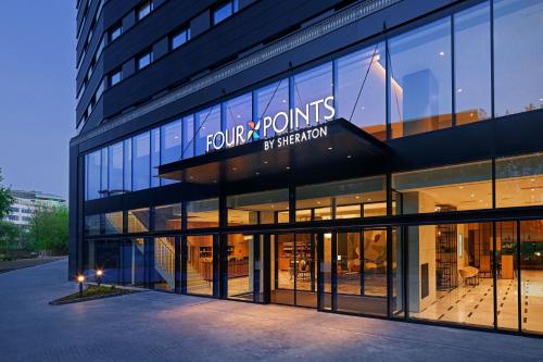 华沙Four Points by Sheraton Warsaw Mokotow的建筑正面景色,上面有标志