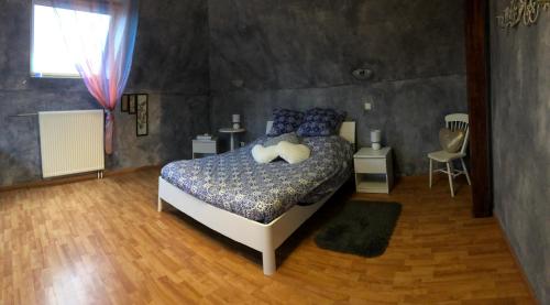 萨维尔纳Maison d’hôtes Au pied du Château的一间卧室配有一张带蓝色枕头的床。