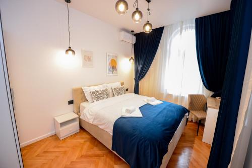 布加勒斯特Villa Maria De Luxe的一间卧室配有一张带蓝色毯子的床