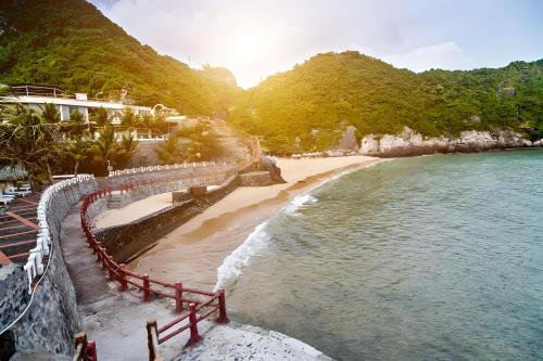 吉婆岛Quang Thang Cat Ba hotel的享有海滩和大海及山脉的美景