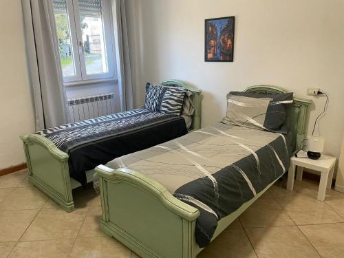 佩鲁贾Casina Gentili的带窗户的客房内设有两张单人床。