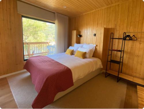 雷森迪Quinta Da Porta Caseira的一间卧室设有一张大床和一个窗户。