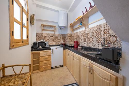 丹吉尔Dar BAB HAHA Petite Maison à la Marocaine的一间带水槽和微波炉的小厨房