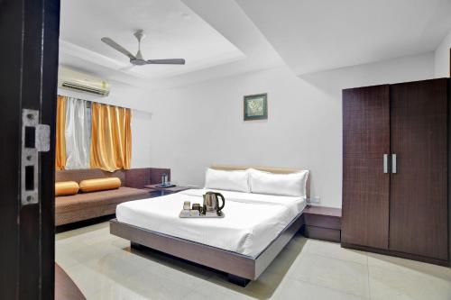 印多尔Townhouse Hotel Divya Palace的酒店客房,配有床和沙发