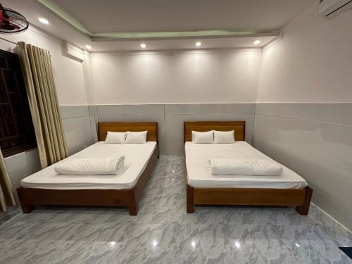 邦美蜀Hoàng Linh Hotel的小房间带两张床,有病