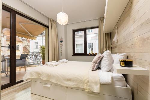 普罗夫迪夫Luxury Central Apartment的一间带大床的卧室和一个阳台