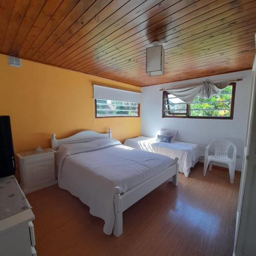 马德普拉塔Increíble casa a 4 cuadras del mar的一间卧室设有两张床和木制天花板