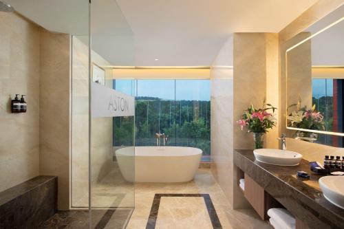 茂物ASTON Sentul Lake Resort & Conference Center的浴室配有2个盥洗盆和1个浴缸。