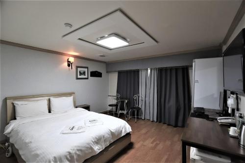 大田Hani Motel的配有一张床和一张书桌的酒店客房