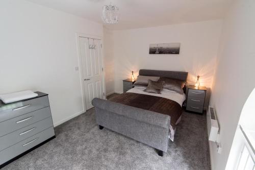StanningleyNazarene apartments in Leeds的一间卧室配有一张床和一个梳妆台
