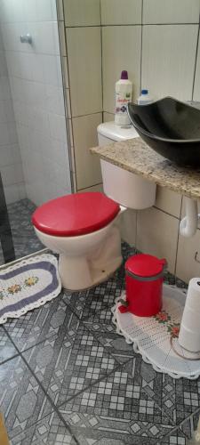 瓜鲁柳斯Meire Hostel的一间带卫生间和红色盖子的浴室