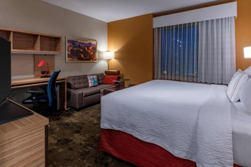 盖洛普TownePlace by Marriott Suites Gallup的配有一张床和一张书桌的酒店客房