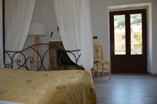 San Mauro CastelverdeAntico Borgo Buonanotte的一间卧室配有一张床,一扇门设有窗户