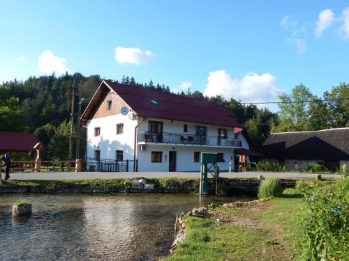 普利特维采湖Guest House Končar的河边的建筑物,有房子