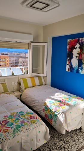 贝利雷瓜尔德RELAX的一间卧室设有两张床,墙上挂着一幅画