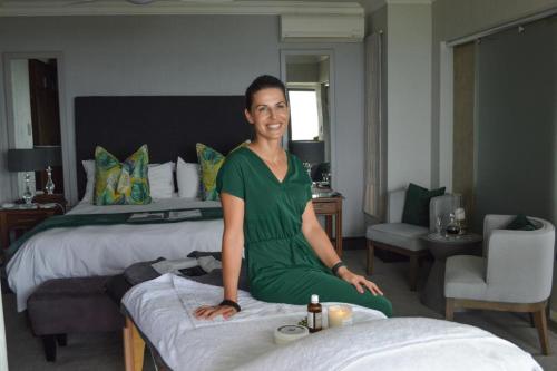 莫塞尔湾非洲海洋庄园酒店的坐在酒店房间床上的女人