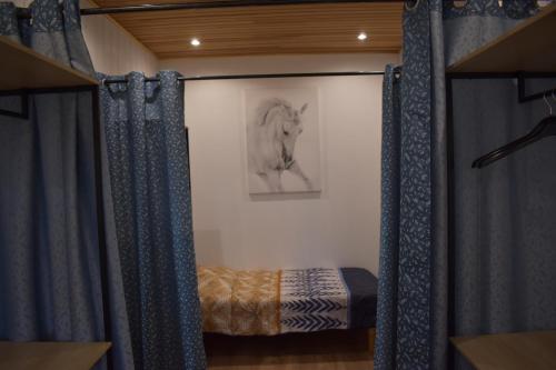 Rigny-UsséGîtes du Franc Rosier的卧室配有一张床,还享有一幅马的照片