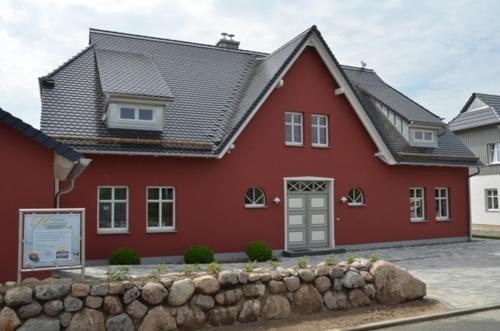 奥特里德维茨Landhaus Hagenblick - Apt. 01的前面有石墙的红色房子