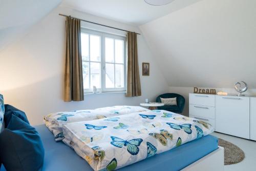 格洛韦Ferienhaus Greta的一间卧室配有带蝴蝶床罩的床