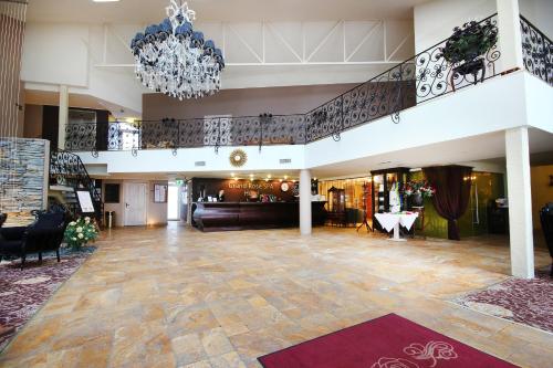 库雷萨雷格兰德玫瑰SPA酒店的一个带吊灯的大大厅和一个大堂