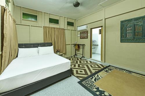 Kampong Sungai MatiOYO HOME 90692 Tok Babah Village Homestay的卧室配有白色的床和门廊。