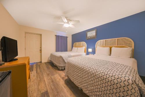 西塞德City Centre Motel by OYO的酒店客房设有两张床和一台平面电视。