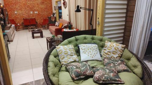 弗洛里亚诺波利斯Graça de Casa的客厅配有带枕头的绿色沙发