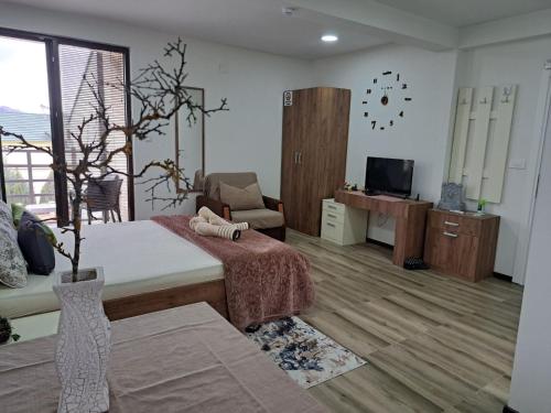 韦莱斯Villa Lucija的客房设有床、沙发和电视。