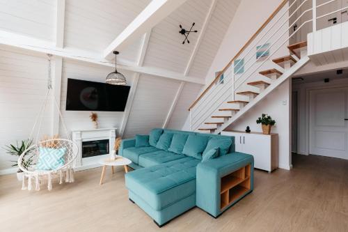 里梅泰亚Black & White Panoramic的客厅设有蓝色的沙发和楼梯。