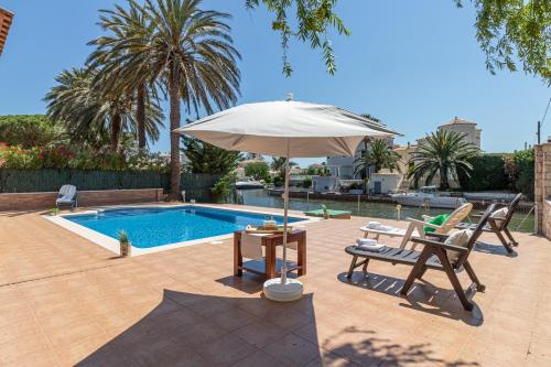 艾姆布里亚布拉瓦Apart-rent Villa Pani 0145的游泳池旁带遮阳伞和椅子的天井