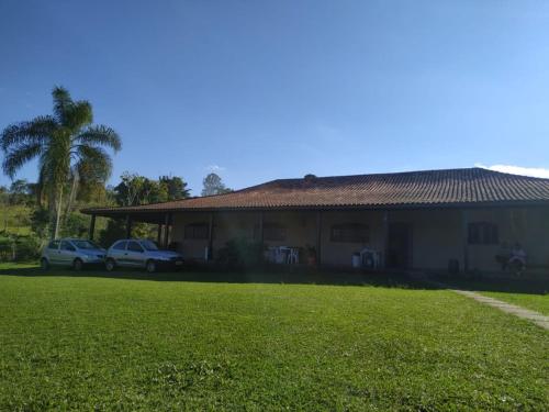 圣伊萨贝尔Sitio do Campo的两辆汽车停在房子前面的房子
