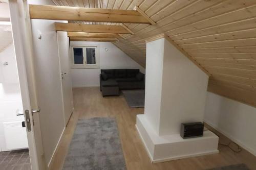 KontiolahtiVilla Mäntysaari luonnonrauhaa kaupungin lähellä.的带沙发和木制天花板的客厅