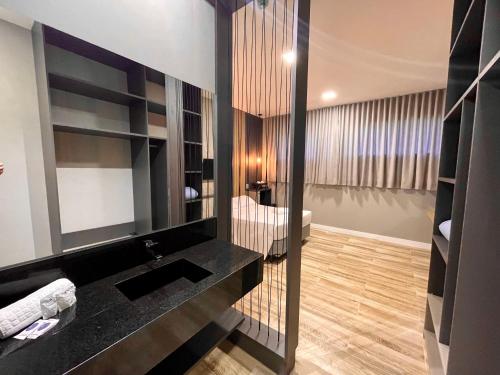 格拉玛多Eleganz Hostel & Suítes的一间带水槽和镜子的浴室
