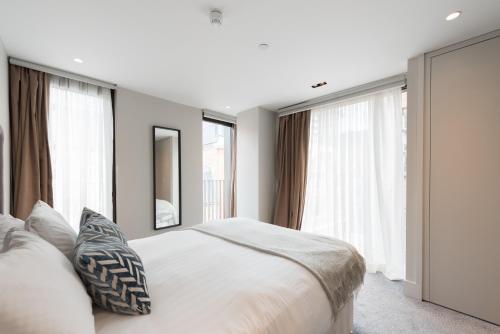 伦敦New Build-Air Con-2 Bedroom-Two Bathrooms Apt 3的卧室设有一张带窗户的白色大床