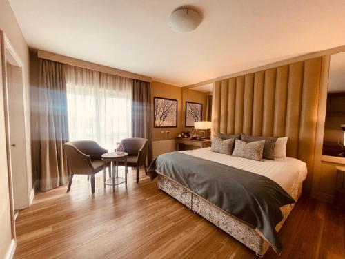 巴利纳斯洛Moycarn Lodge & Marina的酒店客房带一张床、一张桌子和椅子