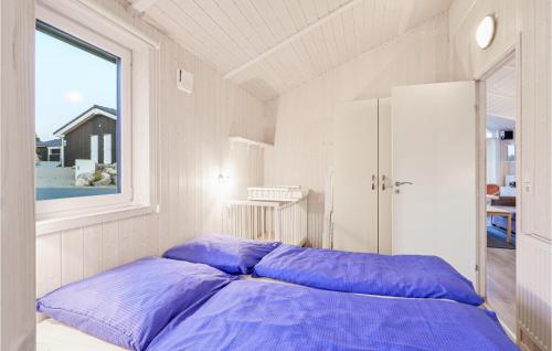 圣安德里斯伯格金星度假屋A的窗户客房内的一张带紫色枕头的床