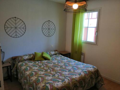 圣皮索内维尔卡提科萨公寓的一间卧室配有一张带绿帘的床和窗户