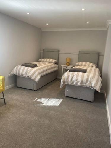 雷德鲁斯Sunny Corner - lovely 2 bedroom appt的一间客房内配有两张床的房间