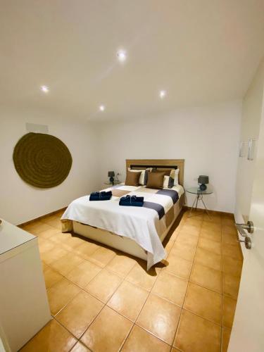 阿索马达Vivienda Vacacional Naia的卧室配有1张床,铺有瓷砖地板。