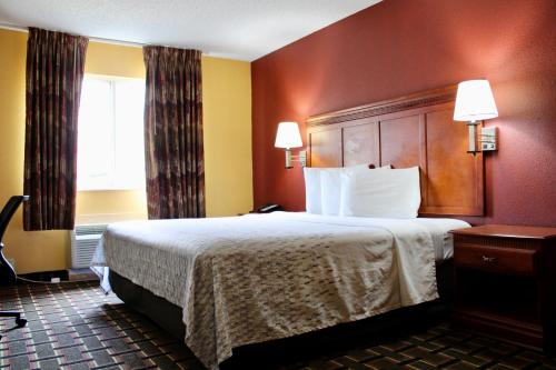 朗维尤HomeTown Inn & Suites的一间设有大床和窗户的酒店客房
