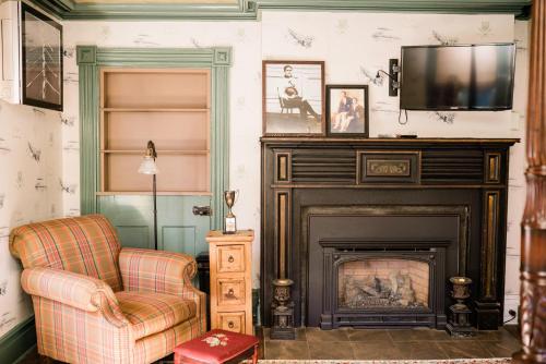 GlenwoodFox & Bear Lodge的客厅设有壁炉、椅子和电视